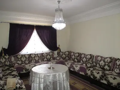 a living room with a couch and a table at Joli spacieux apparrement in Marrakech