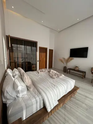 a bedroom with a large white bed with pillows at Villa Signature in Marrakech