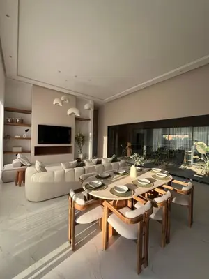 a living room with a couch and a table and chairs at Villa Signature in Marrakech