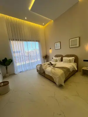 a bedroom with a large bed and a large window at Villa Signature in Marrakech