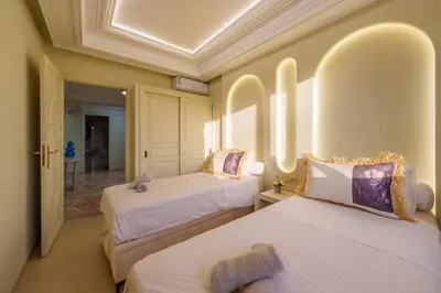 a hotel room with two beds and a hallway at Princess Gueliz center, Comfort, Quiet and View in Oulad Akkou