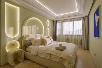 a bedroom with a bed and a large window at Princess Gueliz center, Comfort, Quiet and View in Oulad Akkou