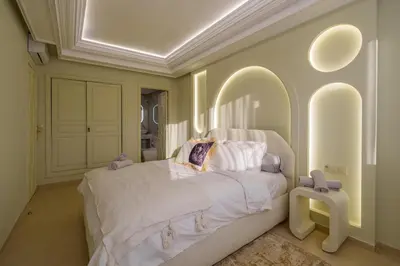 a bedroom with a large bed with white sheets and pillows at Princess Gueliz center, Comfort, Quiet and View in Oulad Akkou
