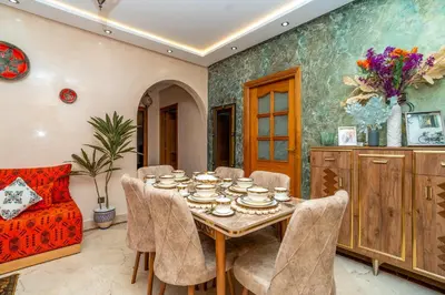 a dining room with a table and chairs at Appart 2Ch Centre Marrakech in Marrakech