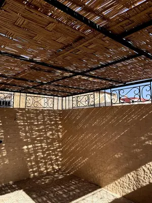 a building with a wooden roof with a shadow on it at Riad Red Diamond in Marrakech