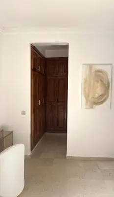 a room with a wooden door and a painting on the wall at Stunning 2BR in Top Location Marrakech City Center in Marrakech