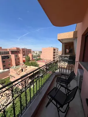 two chairs on a balcony with a view of a city at Stunning 2BR in Top Location Marrakech City Center in Marrakech