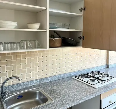 a kitchen counter with a sink and a stove at Stunning 2BR in Top Location Marrakech City Center in Marrakech