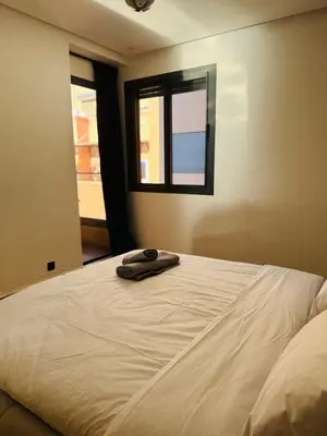 a bed with a towel on it in a bedroom at Chez Yous in Marrakech