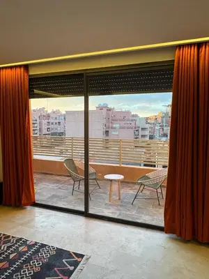 a room with a view of a balcony with a table and chairs at for you - perfect place in Marrakech