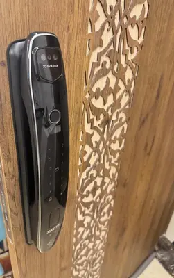 a cell phone hanging on a wooden door at Cozy luxury apartment downtown pool wifi fiber parking in Marrakech