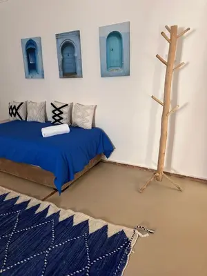 a room with two beds and a tree in it at Villa Léa in Marrakech