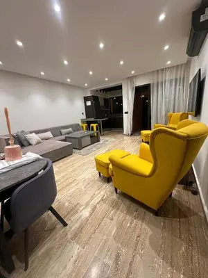 a living room with yellow chairs and a couch at City garden in Marrakech