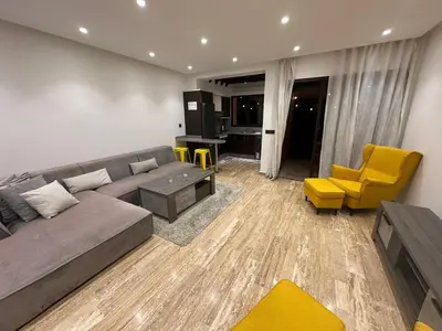 a living room with a gray couch and yellow chairs at City garden in Marrakech