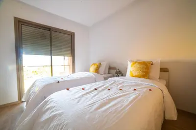 two white beds in a room with a window at Prestigia golf city marrakech in Marrakech