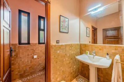a bathroom with a sink and a mirror at Luxury Beldi & Piscine at Villa Riad El Menzeh in Marrakech