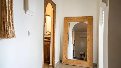 a hallway with a wooden mirror in a room at Manzil Fanny Private Riad & Spa in Marrakech