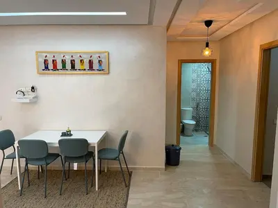 a dining room with a table and chairs and a toilet at 2BRCentral GuelizYSLMajorelle Netflix&100MBfibre in Marrakech