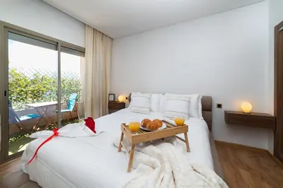 a bedroom with a bed with a tray of food on it at Appartement 2 Chambres Proche Médina Centre Marrakech in Marrakech