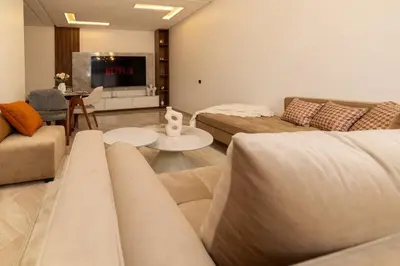 a living room with two couches and a flat screen tv at Appartement 2 Chambres Proche Médina Centre Marrakech in Marrakech