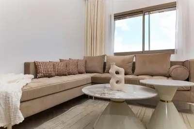 a living room with a couch and a table at Appartement 2 Chambres Proche Médina Centre Marrakech in Marrakech