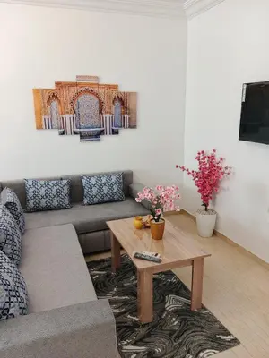 a living room with a couch and a coffee table at Appartement Lady Plaza 1 in Marrakech