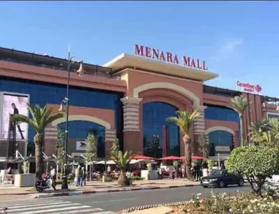 a shopping mall with palm trees in front of it at Appartement Haut Standing Hivernage, Piscine, Centre Marrakech in Marrakech