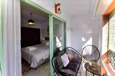 a bedroom with a bed and a table and chairs at Appartement Haut Standing Hivernage, Piscine, Centre Marrakech in Marrakech