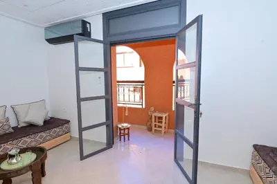 a room with a glass door leading into a living room at Appartement spacieux de 3 chambres à gueliz in Marrakech