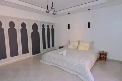 a bedroom with a bed and a wall with silhouettes of people at Appartement spacieux de 3 chambres à gueliz in Marrakech