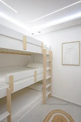 a bunk bed in a room with white walls at 5-Star Duplex - Private Pool in Marrakech
