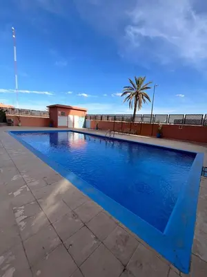 a large blue swimming pool on top of a building at Appartement Majorelle in Marrakech