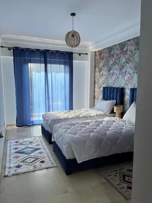 a bedroom with two beds and a window at Appartement Majorelle in Marrakech