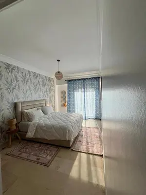 a bedroom with a bed and a large window at Appartement Majorelle in Marrakech