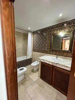 a bathroom with a toilet and a sink and a tub at Appartement Majorelle in Marrakech