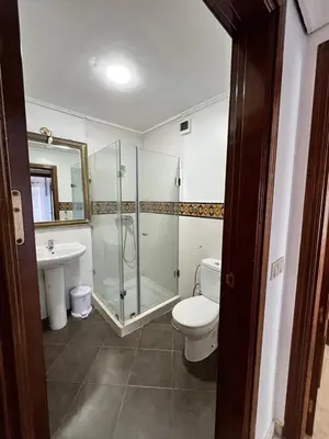 a bathroom with a shower and a toilet and a sink at Appartement Majorelle in Marrakech