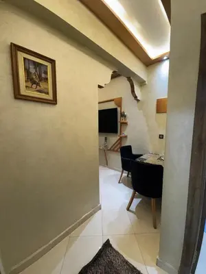 a hallway with a living room with a table at 2 bedroom apartment in a perfect location in Marrakech