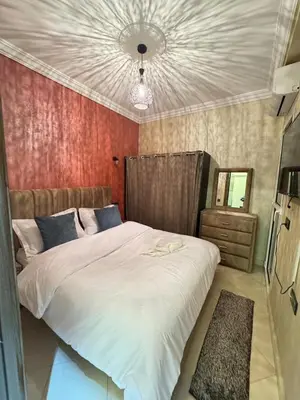 a bedroom with a large white bed and a mirror at 2 bedroom apartment in a perfect location in Marrakech