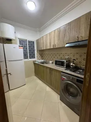a kitchen with a refrigerator and a washing machine at 2 bedroom apartment in a perfect location in Marrakech