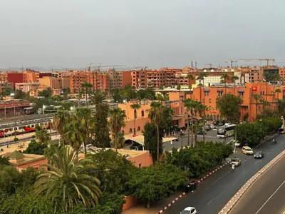 a city with a street with cars and buildings at Hivernage & Gueliz Luxury Apt Pool near medina in Marrakech