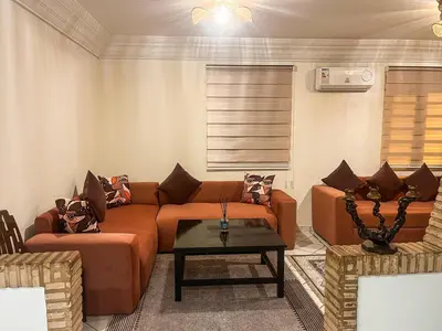 a living room with a couch and a table at appartement en résidence in Marrakech
