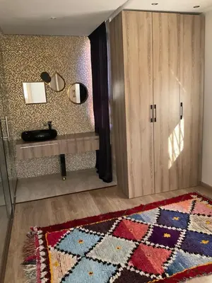a room with a rug on the floor and a cabinet at jhome in Marrakech