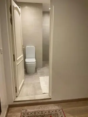 a bathroom with a toilet and a door open at jhome in Marrakech