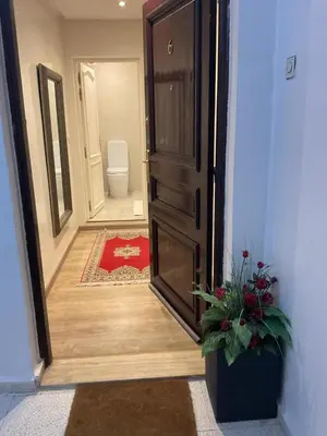 an open door to a bathroom with a toilet and a plant at jhome in Marrakech