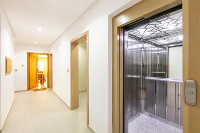 a hallway with a glass door and a walkway at Warm Nest 8 Comfort And Luxury in Oulad Akkou