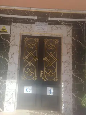 a door in a building with a sign on it at Appartement cosy Marrakech in Marrakech
