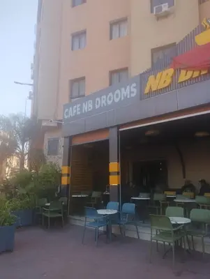 a restaurant with tables and chairs in front of a building at Appartement cosy Marrakech in Marrakech