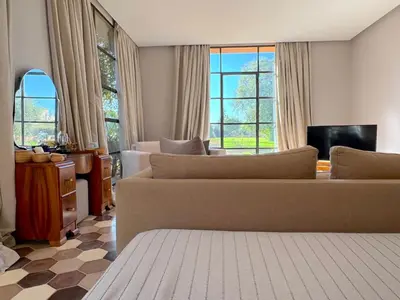 a living room with two couches and a tv at Palais Meryem in Marrakech