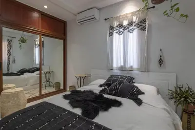 a bedroom with two beds and a large mirror at Dar Choway Ground Floor Apartment in Marrakech