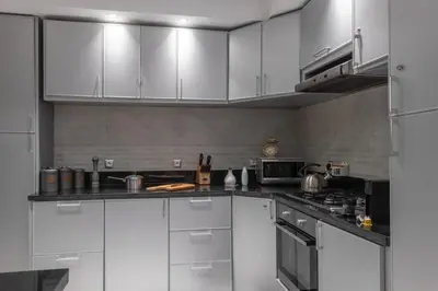 a kitchen with white cabinets and a stove at Dar Choway Ground Floor Apartment in Marrakech